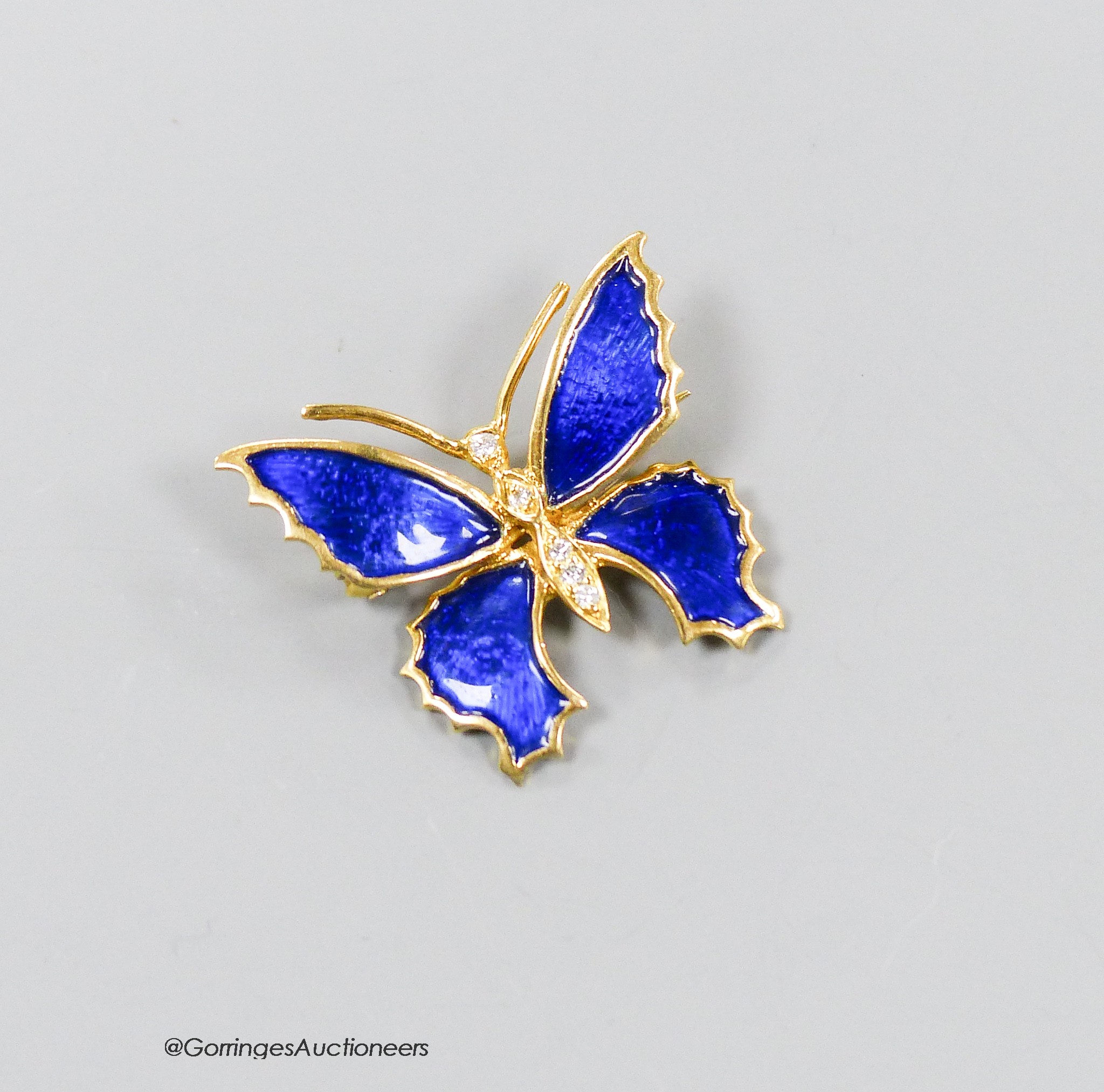 A modern 18ct gold, blue enamel and diamond set butterfly brooch, 22mm, gross weight 5.7 grams.